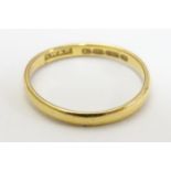 A 22ct gold band, the ring approx size M (2g) Please Note - we do not make reference to the