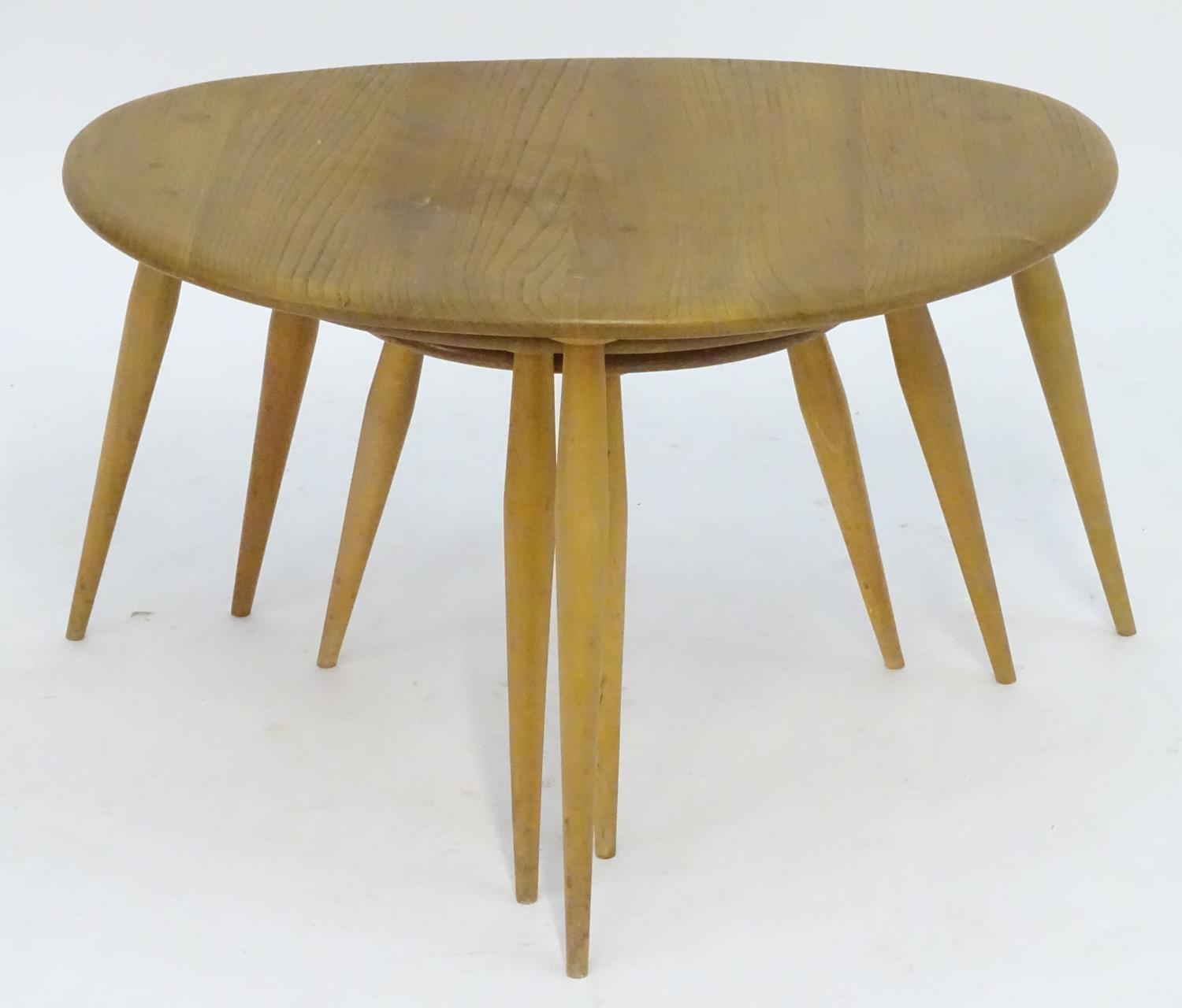 Vintage Retro, Mid-Century: an Ercol elm and beech graduated nest of three tripod tables, the - Image 3 of 4