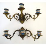 Lighting: a pair of early 20thC triple wall sconces, of gilt brass construction with ornamental