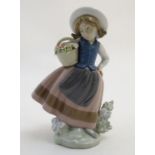 A Lladro figure of a girl holding a basket of flowers, Sweet Scent, model no. 5221. Marked under.
