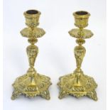 A pair of late 19th / early 20thC cast brass candlesticks with foliate decoration. Approx. 6 1/2"