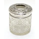 A silver and cut glass hair tidy. The top hallmarked Sheffield 1911 maker Walker & Hall. 3 1/4" high