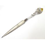 A letter opener with silver handle having thistle decoration . Hallmarked Bimirngahm1910 maker