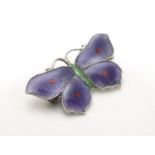 A silver brooch formed as a butterfly decorated with guilloche enamel decoration. Maker John