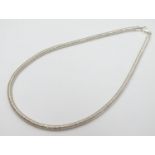 A silver necklace of slinky choker style. Approx 16" long Please Note - we do not make reference