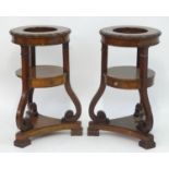 A pair of mahogany jardiniere stands with egg and dart moulded decoration, scrolled supports and
