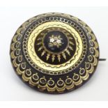 A Victorian faux tortoiseshell brooch with piquet work detail. Approx 1 3/4" diameter. Please Note -