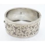 A Victorian silver bracelet of cuff bangle form with engraved decoration. hallmarked Birmingham 1884
