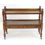 An early 20thC mahogany buffet with two tiers above two short drawers and raised on turned