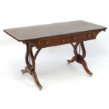 A 19thC mahogany sofa table / writing desk with a cross banded top above two short drawers with
