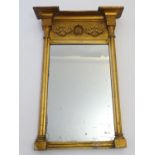 A 19thC pier mirror with floral decoration and flanked by cluster columns. 17" wide x 25" high.