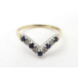 A 9ct gold ring set with diamonds and blue spinel in a wishbone setting. Ring size approx O Please