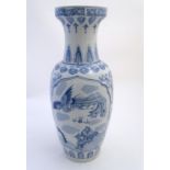 A large Chinese blue and white vase decorated with flowers, foliage and a stylised phoenix and