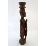 Ethnographic / Native / Tribal: A carved wooden figure of a seated man. Approx. 22" overall Please