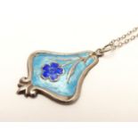 A white metal pendant and chain, the pendant with Art Nouveau gullicohe enamel style decoration and