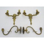 A pair of 20thC brass, twin-branch wall lights (10" wide, 8 1/4" tall, protruding 4 3/4") together