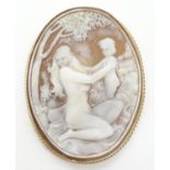 A cameo brooch the shell carved cameo depicting a woman and child, within a 9ct gold mount. 2 1/4"