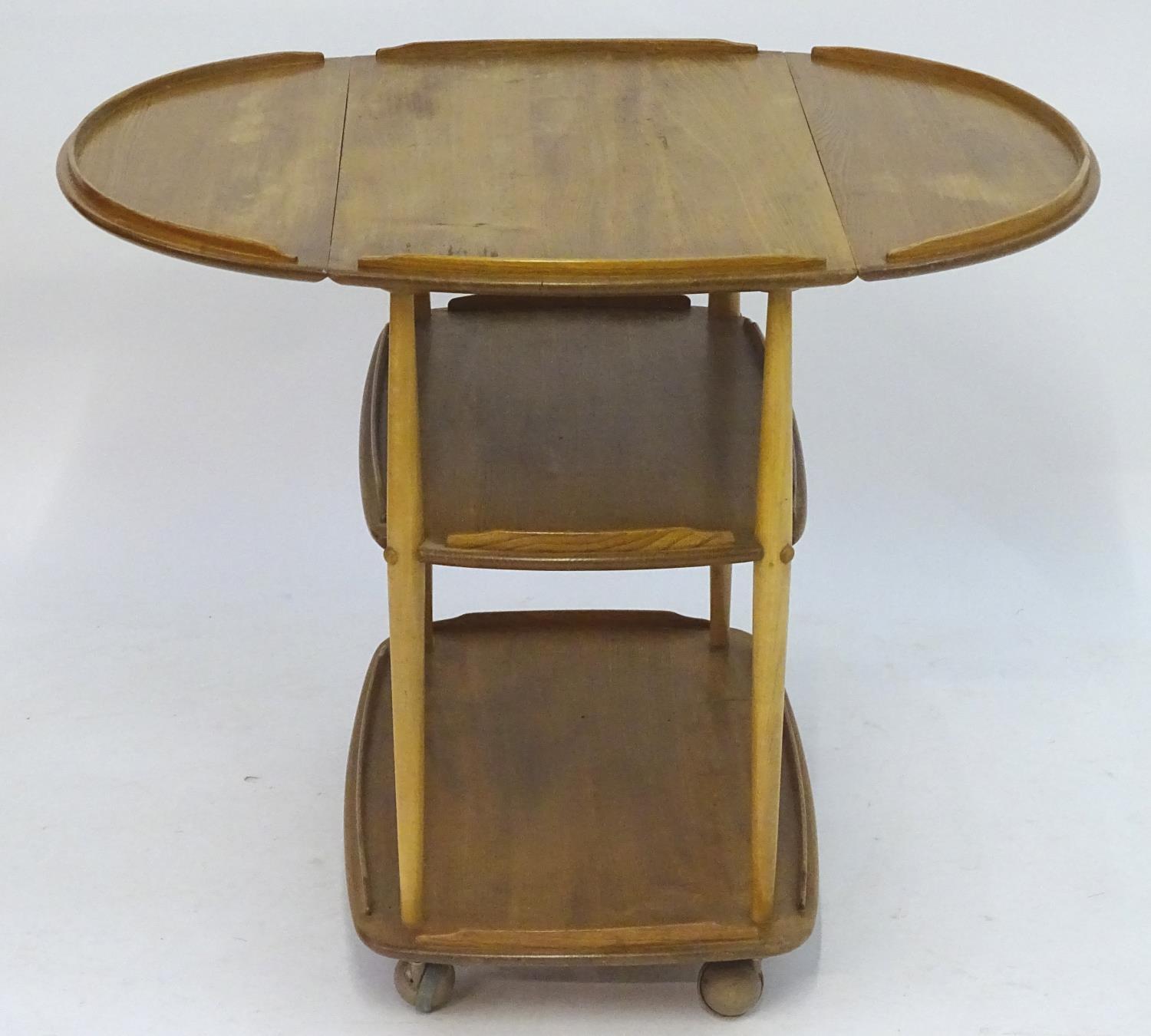 Vintage Retro, Mid-Century: an Ercol elm and beech three tiered trolley, the top with drop flaps, - Image 5 of 5