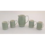 A mid 20thC Keith Murray Wedgwood lemonade / beer set, comprising a moonstone jug and four tankards,