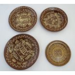 Four 20thC slipware chargers decorated with abstract patterns, one with a border bearing Historic