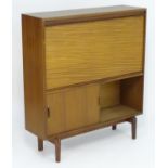 Vintage Retro, Mid-Century: a teak drinks cabinet by Beaver & Tapley Ltd, London, labelled 'Multi-