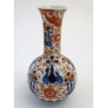 An Oriental globular vase in the Imari palette with an elongated neck with a flared rim, decorated