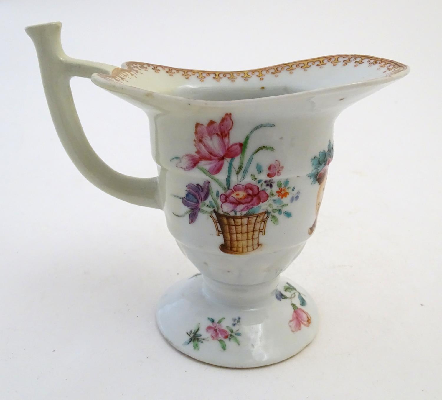 A late 18th / early 19thC Chinese export helmet jug with hand painted floral and cipher monogram