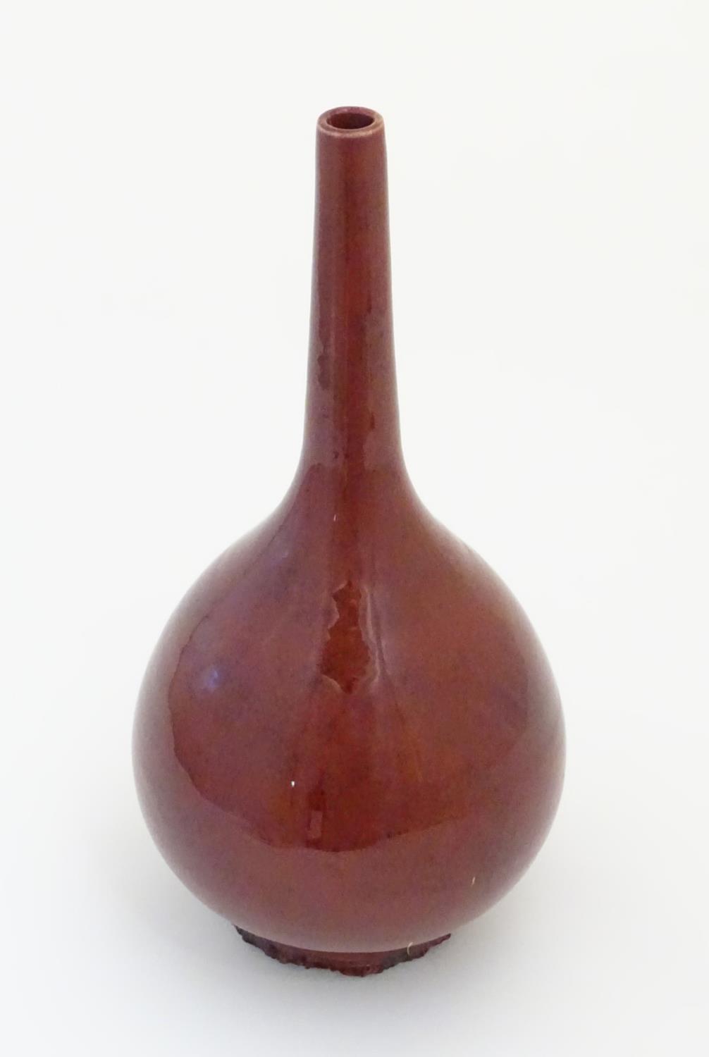 A Chinese globular vase with a slender, elongated neck with a sang de boeuf glaze. Approx. 17 1/ - Image 4 of 5