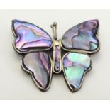 A vintage Mexican brooch formed as a butterfly with paua / abalone shell detail. A 3/4" long