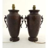 A pair of late-19thC Japanese bronze lamps, with burnished patinated finish, twin handles and