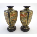 A pair of Japanese Satsuma vases of square baluster form with a cobalt blue ground, with panelled