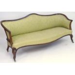 A large 19thC sofa with a walnut show wood frame and camel back above an upholstered backrest and