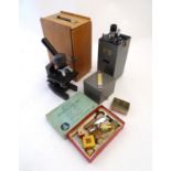 A mid to late 20thC boxed microscope, together with slides and portable projector. Please Note -