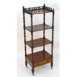 A mid 19thC mahogany whatnot with a fretwork gallery above four serpentine shaped tiers with