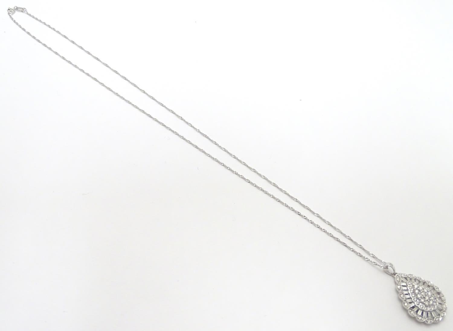 A 9ct white gold pendant set with a profusion of diamonds, on an 18" long and. The pendant approx 1" - Image 3 of 7
