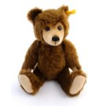 A Stieff brown bear with mohair fur, felt pads, articulated limbs and growler. Approx. 14 1/4"