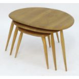 Vintage Retro, Mid-Century: an Ercol elm and beech graduated nest of three tripod tables, the