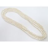 A long string of pearls. The necklace approx 100" long Please Note - we do not make reference to the