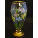 An early 20thC clear glass vase, with gilt base and rim, decorated with polychrome enameled