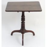 A late 18thC oak tripod table with a rectangular top above a tapering turned pedestal and three