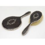 A silver and tortoiseshell backed hand mirror and brush, hallmarked Birmingham 1919 maker E S