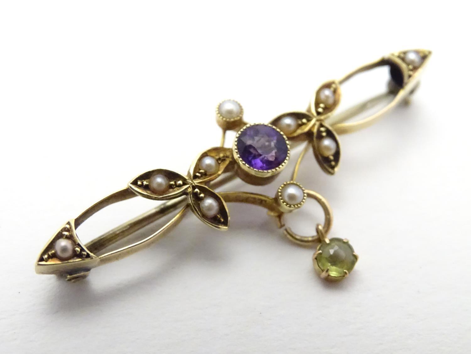 Suffragette jewellery : An early 20thC 15ct gold brooch set with amethyst, seed pearls and peridot ( - Image 4 of 5