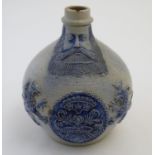 A 19thC German Bellarmine / Bartmann jug with bearded man to the neck and a coat of arms with
