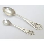 A teaspoon and a mustard spoon both with thistle decoration to handles, the teaspoon hallmarked