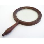 A 19thC magnifying glass with a wooden frame and handle. Approx. 8 3/4" long Please Note - we do not
