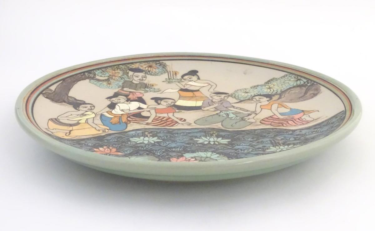 An Oriental plate, the unglazed centre decorated with a group of people in a landscape relaxing near - Image 2 of 8