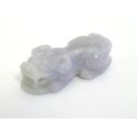An Oriental carved jade figure modelled as a stylised animal. Approx. 1 1/4" long Please Note - we