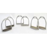Three pairs of equestrian / horse stirrup irons, to include Fillis 4 1/4" with treads, 4", and 4 1/
