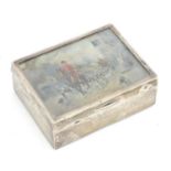 A silver table top cigarette box with hunt scene to lid depicting huntsman and hounds riding through