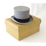 A Gieves of London grey felt top hat with a black trim, size 7 1/8 Contained within original card